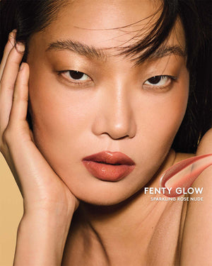 Gloss Bomb Oil Luminizing Oil and Gloss in shade Fenty Glow on a light skin tone. Fenty Glow is a sparkling rose nude.