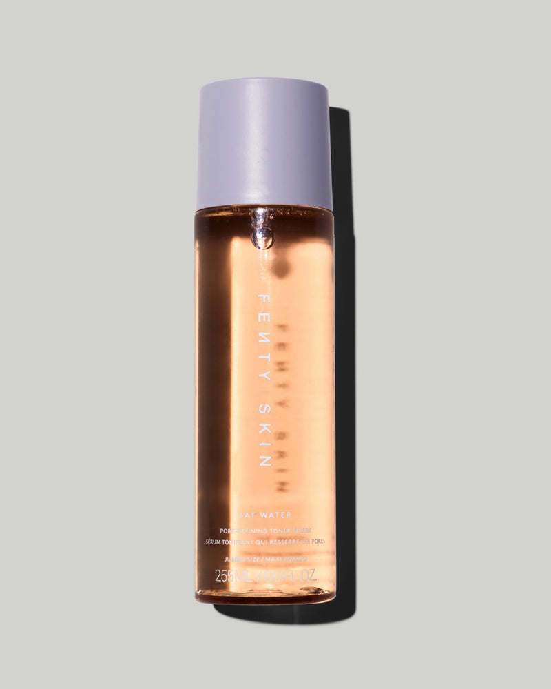 A bottle of Fat Water Toner Serum against a lilac backdrop.