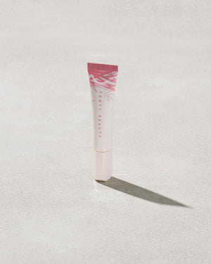 Closed Tube of Pro Kiss'r Luscious Lip Balm in shade Pinch Me on grey background.