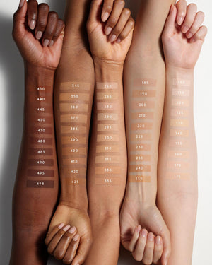Fenty Beauty's collection of Pro Filt'r Soft Matte Longwear Foundation shades for light, light-medium, medium, medium-deep or tan, and deep skin tones shown as arm swatches on models of various skin tones