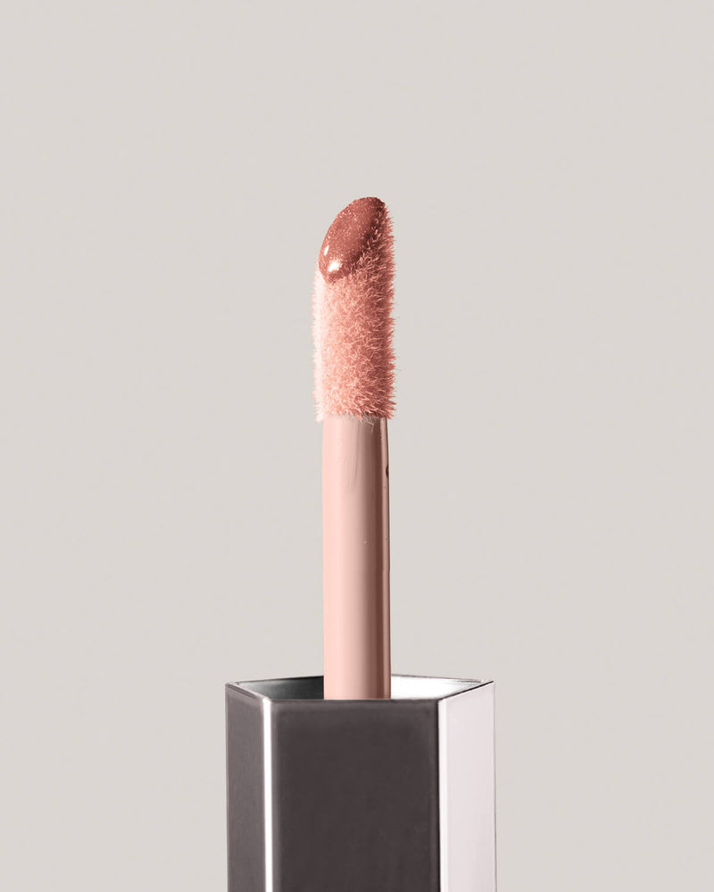 Fenty Beauty GLOSS BOMB UNIVERSAL LIP LUMINIZER in shade Fenty Glow close up of doe foot applicator
