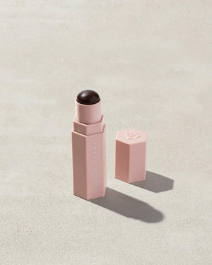 Opened Match Stix Contour Skinstick in the shade Caviar container on a grey background.